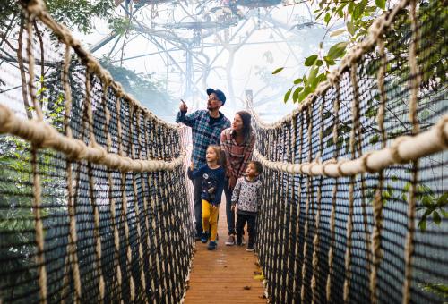 Family on rope bridge in Rainforest Biome at Eden Project